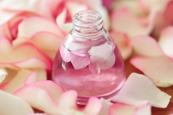 Essential oil with petals — Stock Photo, Image