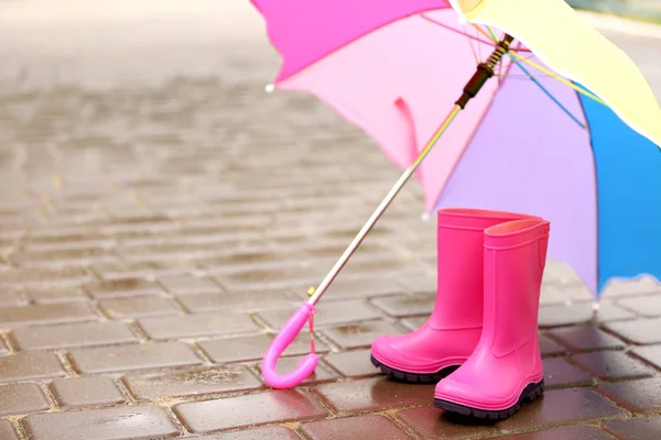 Colorful umbrella and gumboots — Stock Photo, Image