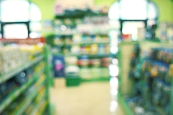 Blurred view of packs with animal food — Stock Photo, Image