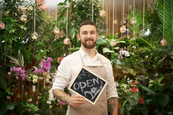 Handsome florist holding board