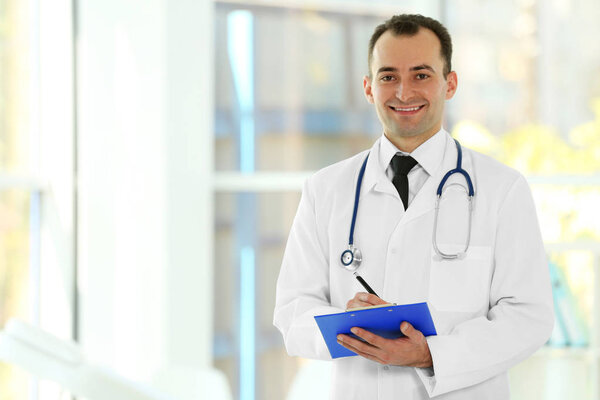 Doctor with clipboard at hospital