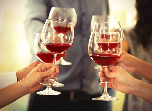 People toasting with glasses