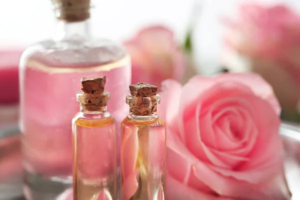 Bottles of aroma oil with flower roses — Stock Photo, Image