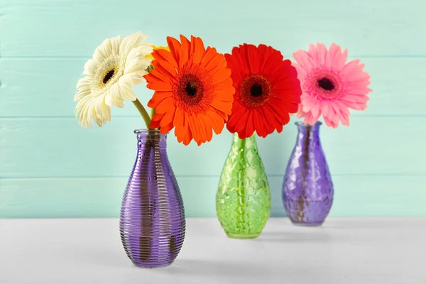 Beautiful gerbera flowers in vases — Stock Photo, Image