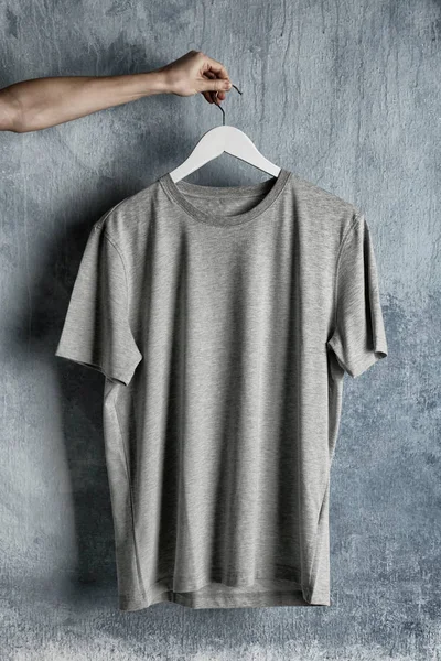 gray t-shirt against grunge wall
