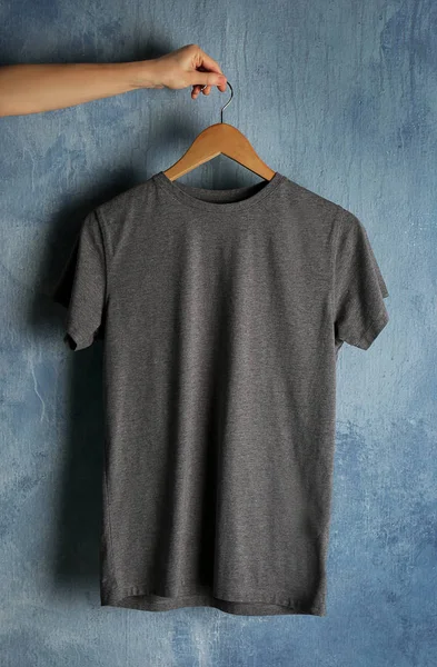 gray t-shirt against grunge wall