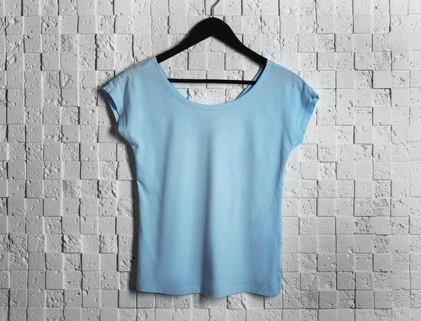 Blue t-shirt against brickwall — Stock Photo, Image