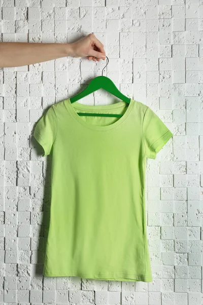 Green t-shirt against brickwall — Stock Photo, Image