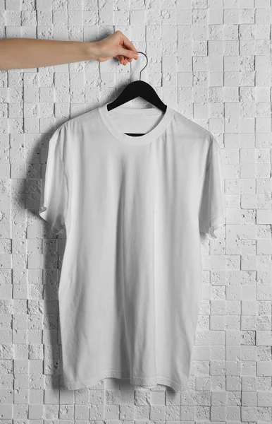 White t-shirt against brickwall — Stock Photo, Image