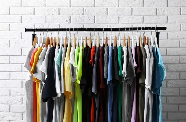 Colorful t-shirts on hangers — Stock Photo, Image