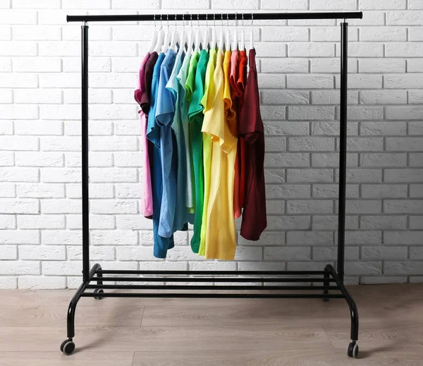 Colorful t-shirts on hangers — Stock Photo, Image