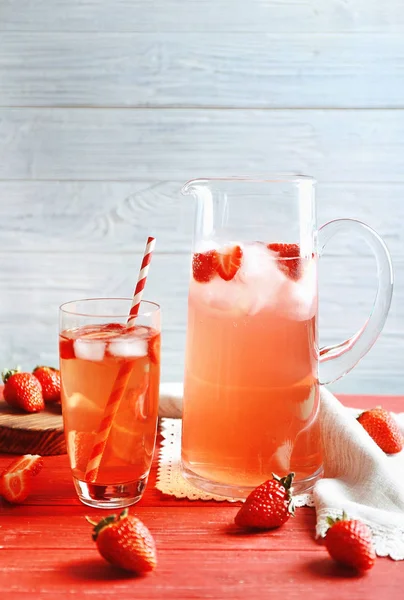 Glass and jug of strawberry drink — Stock Photo, Image