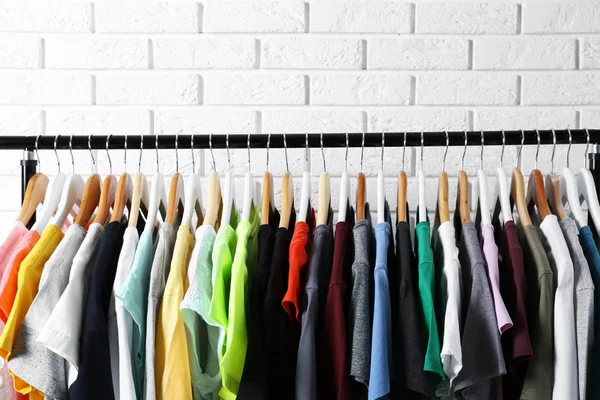 Colorful t-shirts on hangers — Stock Photo, Image