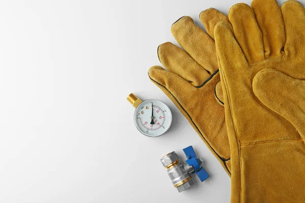 Plumber tools with yellow gloves — Stock Photo, Image