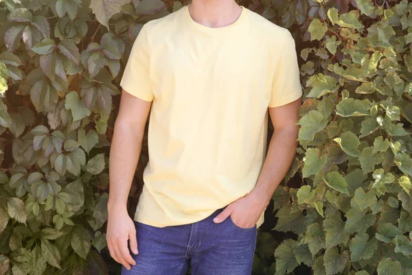 Man on green leaves — Stock Photo, Image