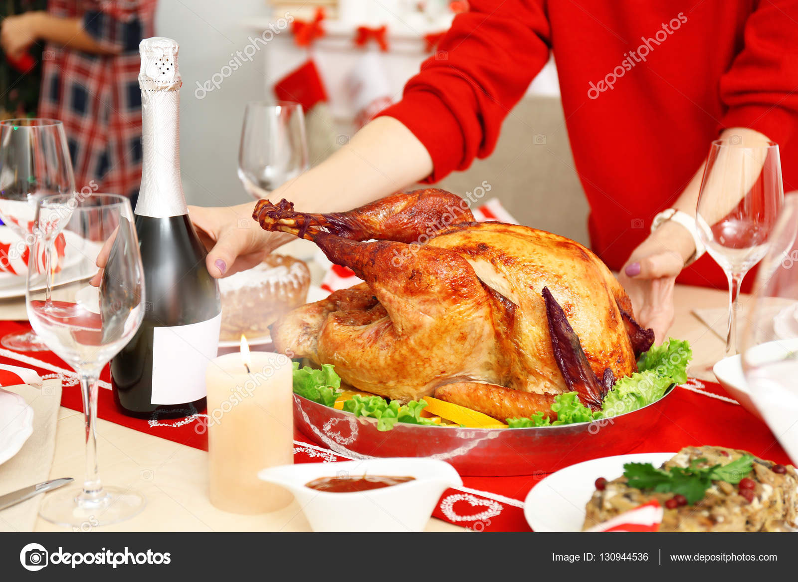 Woman serving table for Thanksgiving dinner Stock Photo by ©belchonock 130944536
