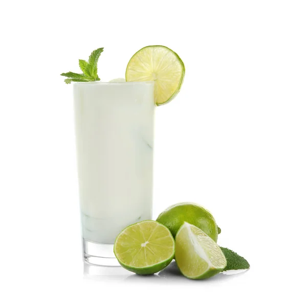 Glass with tasty milk shake and lime — Stock Photo, Image