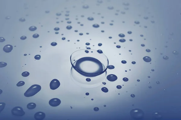 Contact lens on smooth wet background — Stock Photo, Image