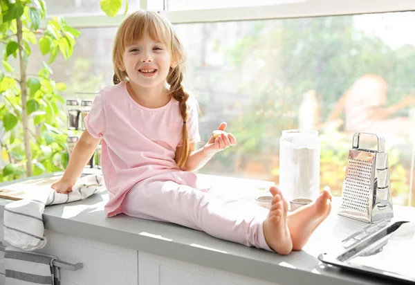 Söt liten flicka sitter på bord — Stockfoto