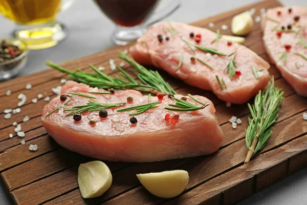 Steaks in marinade on board — Stock Photo, Image