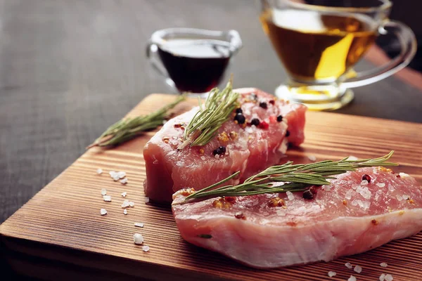 Raw steaks with herb — Stock Photo, Image