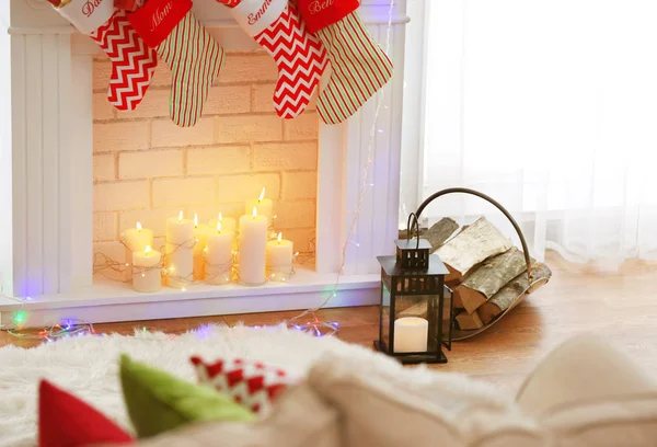 Fireplace with candles and vintage lantern — Stock Photo, Image