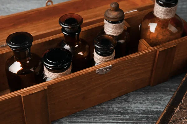 Vintage glass bottles in wooden box — Stock Photo, Image