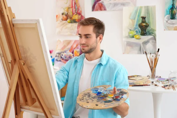 male artist painting picture