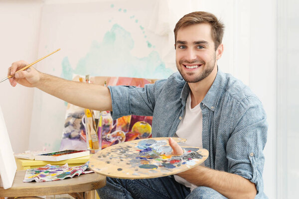 male artist painting picture