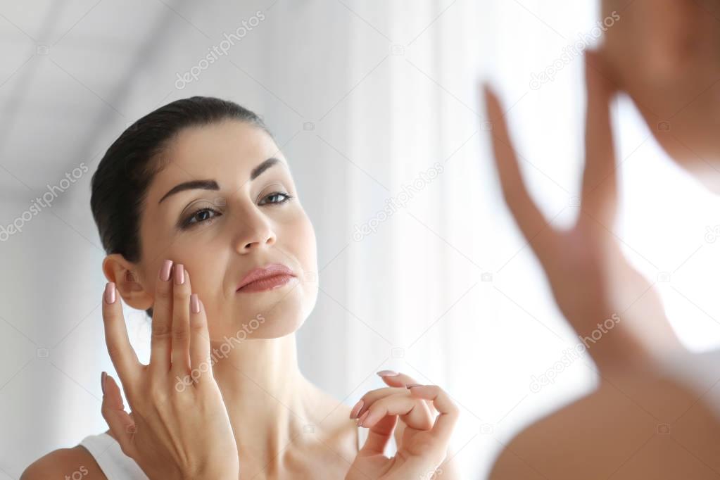 Adult woman checking her face