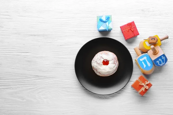 Donut, dreidels and presents for Hanukkah — Stock Photo, Image