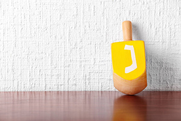 Dreidel for Hanukkah on table 