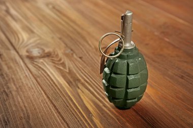 Close up view of hand grenade on wooden background clipart