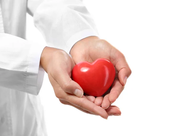 Red plastic heart in female hands — Stock Photo, Image