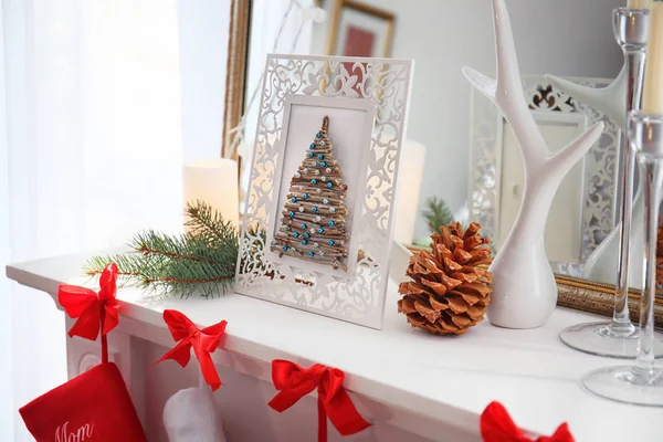 Handmade Christmas tree in photo frame on mantelpiece — Stock Photo, Image