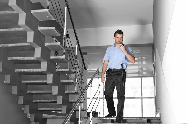 Security man walking on stairs — Stock Photo, Image