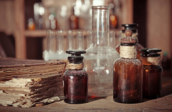 Old book with glass bottles