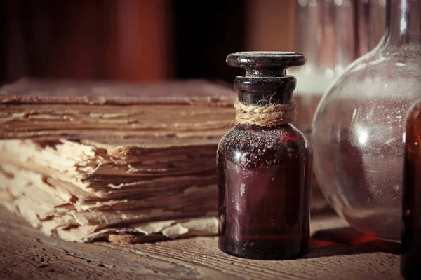 Old book with glass bottles — Stock Photo, Image