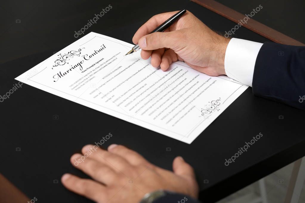 Man signing marriage contract