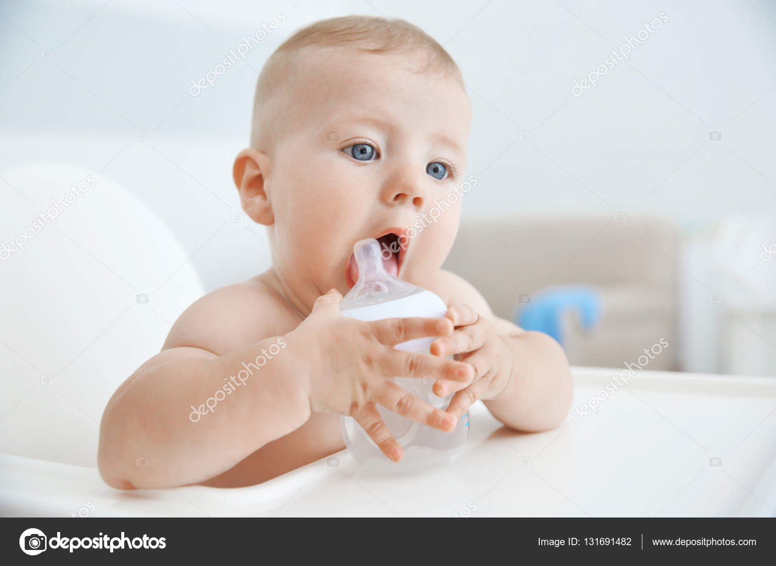 Little baby drinking water from bottle indoors — Stock Photo