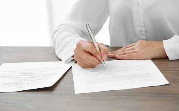 Successful businesswoman signing documents in office, close up view — Stock Photo, Image