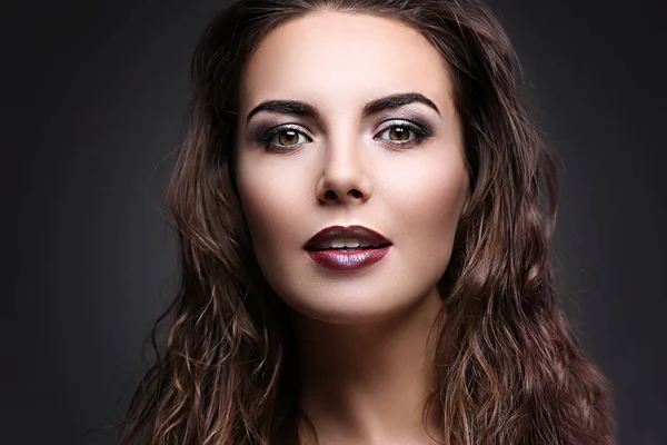 Portrait of beautiful young woman model with bright makeup on dark background — Stock Photo, Image