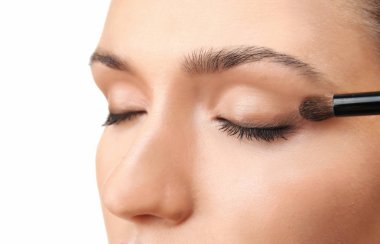 Güzel kız beyaz arka plan üzerinde kozmetik uygulama