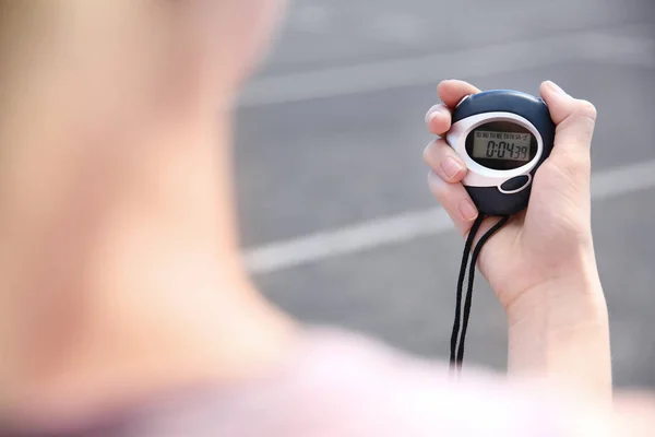 Female hand holding digital stopwatch, close up — Stock Photo, Image