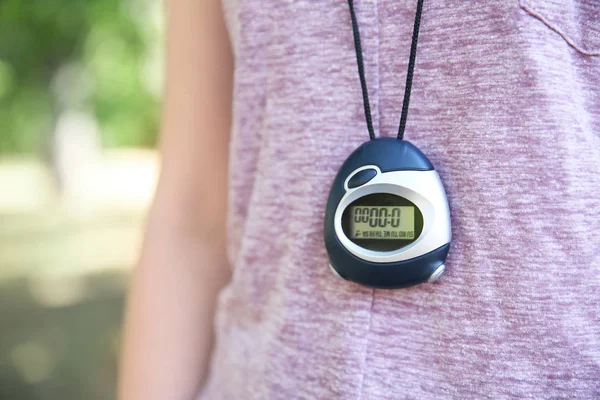 Digital stopwatch hanging on female neck — Stock Photo, Image