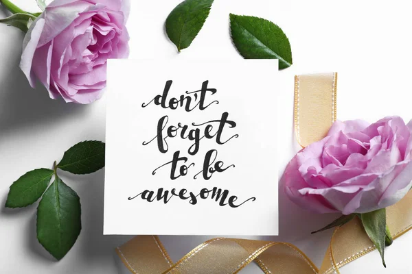 Inscription "DON'T FORGET TO BE AWESOME" written on paper with flowers and ribbon on white background — Stock Photo, Image