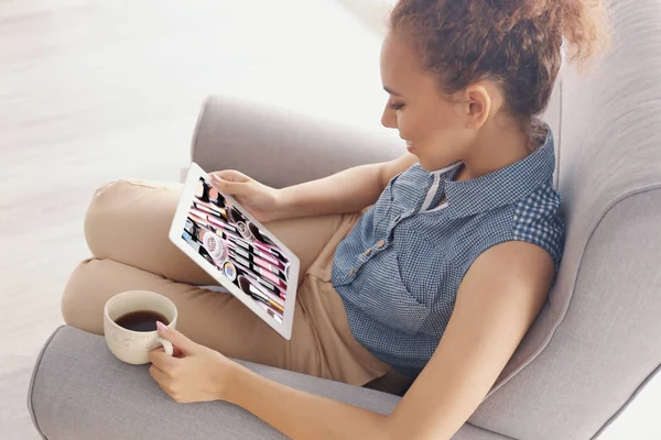 Woman watching online tutorial on tablet. Makeup and beauty blog.