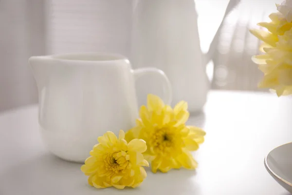 Yellow chrysanthemum at milk jug