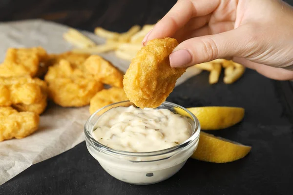 Woman holding tasty nugget — Stock Photo, Image