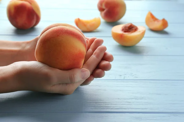 Juicy peach in female hands